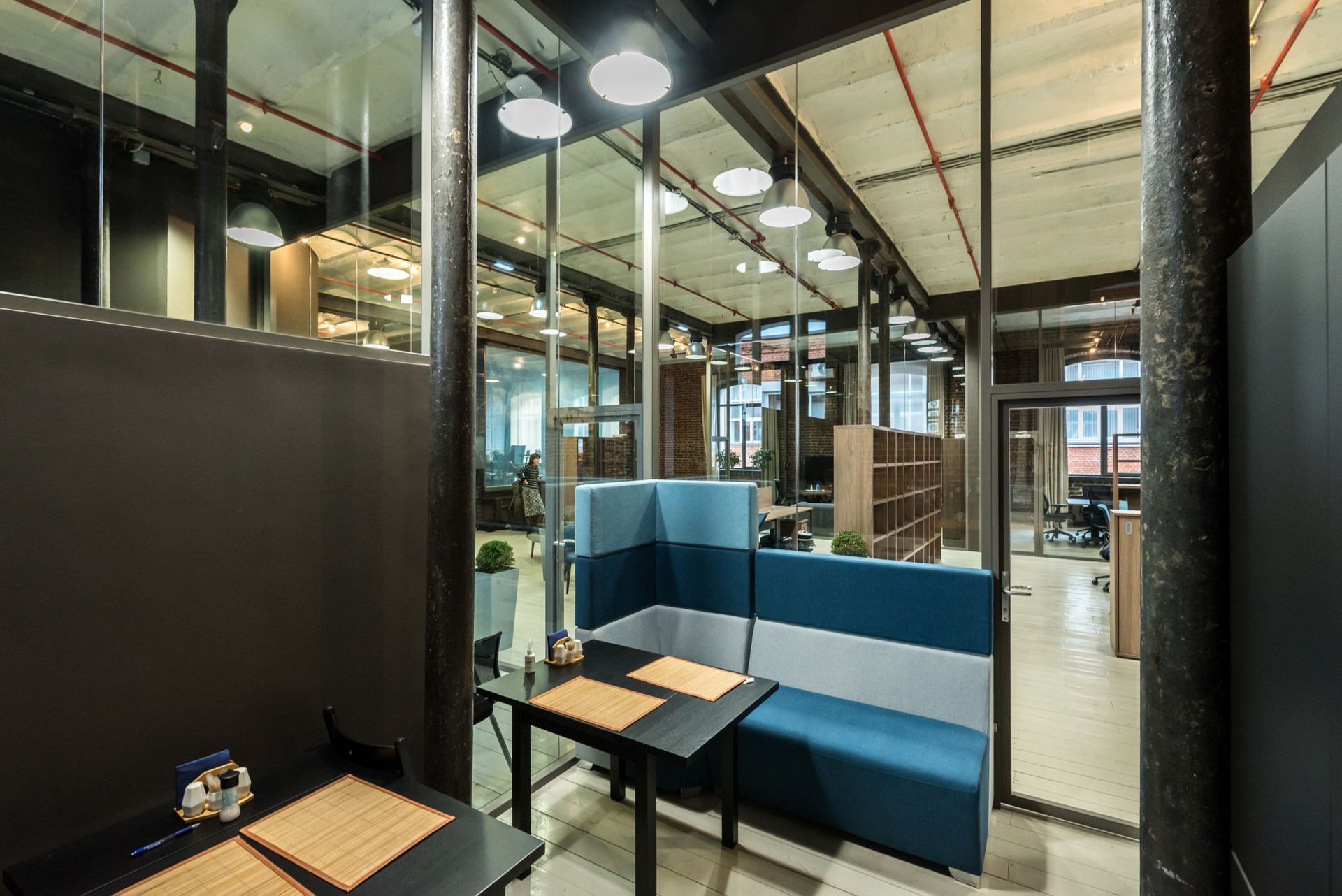 Стеклянные перегородки в офисе лофт с кирпичными стенами